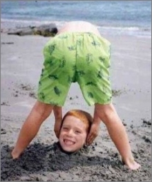 funny photo boy beach head buried